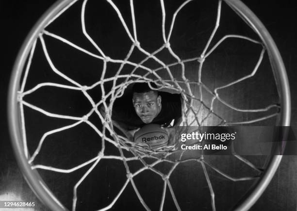 This image has been converted to black and white) Allen Iverson, Shooting Guard and Point Guard for the Philadelphia 76ers looks up through the net...