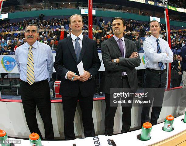 Goaltender coacher Jim Corsi, assistant coaches Kevyn Adams, Teppo Numminen and James Patrick of the Buffalo Sabres watch warmups before their game...