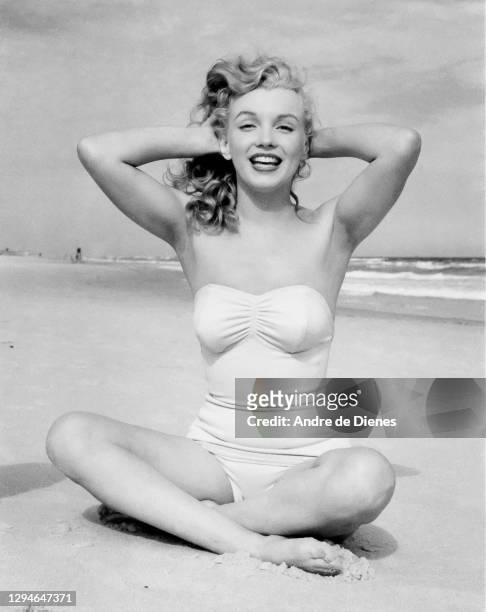 Portrait of American actress and model Marilyn Monroe , in a swimsuit, as she poses on Long Island's Tobay Beach, Oyster Bay, New York, 1949.