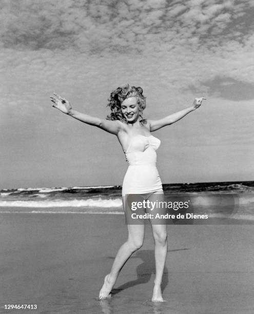 Portrait of American actress and model Marilyn Monroe , in a swimsuit, as she poses on Long Island's Tobay Beach, Oyster Bay, New York, 1949.