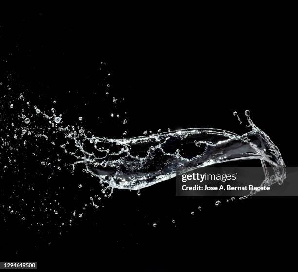 splashes, jet and drops of water in motion suspended in the air on a black background. - air waves stockfoto's en -beelden