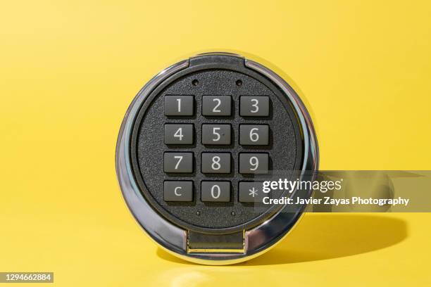 safety lock pad on yellow background - digital lockbox stock pictures, royalty-free photos & images