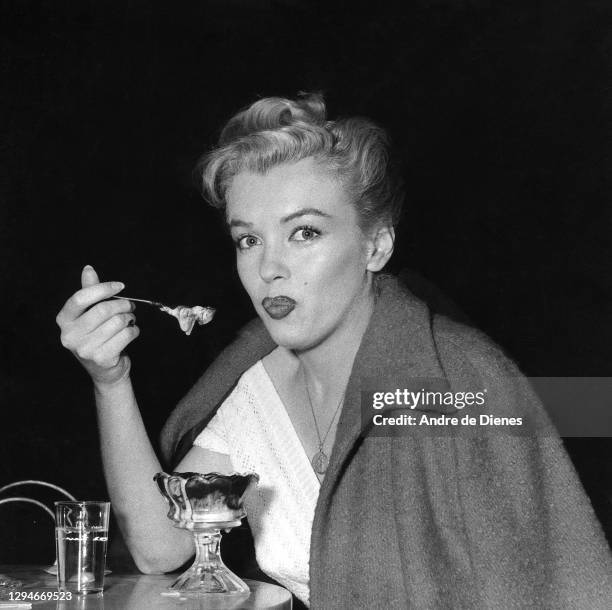 Portrait of American actress and model Marilyn Monroe as she eats a sundae in an ice cream parlor, Hollywood, California, 1953.