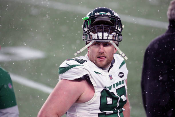 Henry Anderson of the New York Jets follows the action in the snow against the New England Patriots at Gillette Stadium on January 3, 2021 in...