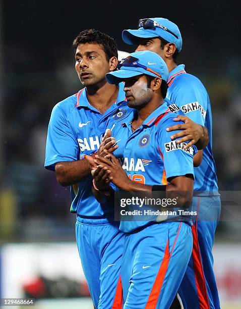 Indian bowler Vinay Kumar is congratulated by teammate Praveen Kumar for a brilliant spell of 9 overs in which he gave away only 30 runs and took 4...