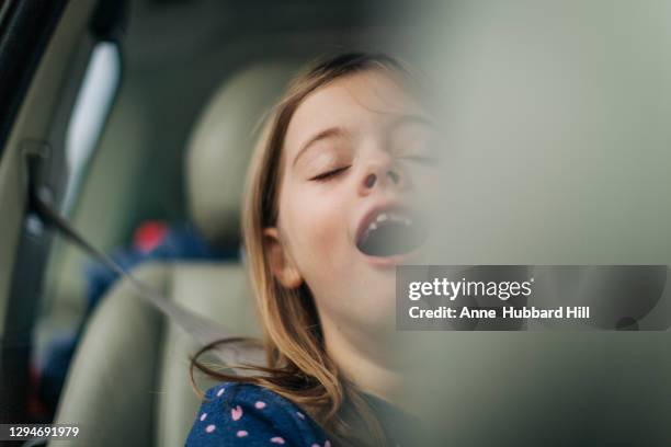 young girl in backseat eyes closed singing - singing for kids stock pictures, royalty-free photos & images
