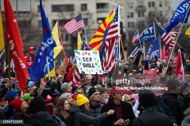 President Donald Trump supporters listen to speeches and hold up signs on January 5, 2021 at Freedom Park in Washington, DC. Today's rally kicks off...