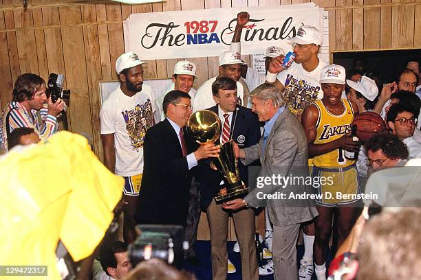 Commissioner David Stern presents Jerry Buss the 1987 NBA Finals Championship trophy following Game Six of the 1987 NBA Finals on June 14, 1987 at...