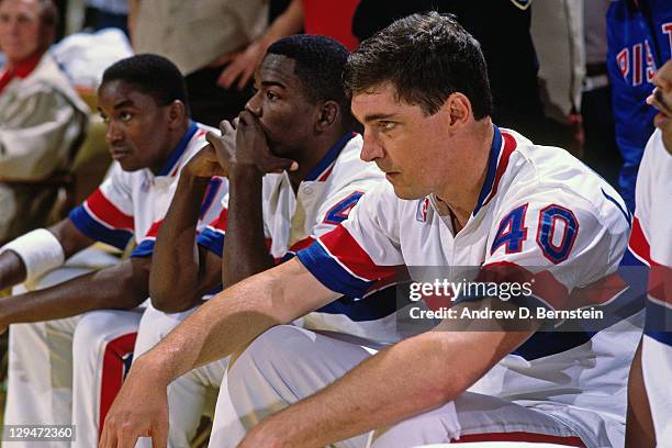 Isiah Thomas, Joe Dumars and Bill Laimbeer of the Detroit Pistons sit on the bench during Game Five of the 1988 NBA Finals on June 16, 1988 at the...