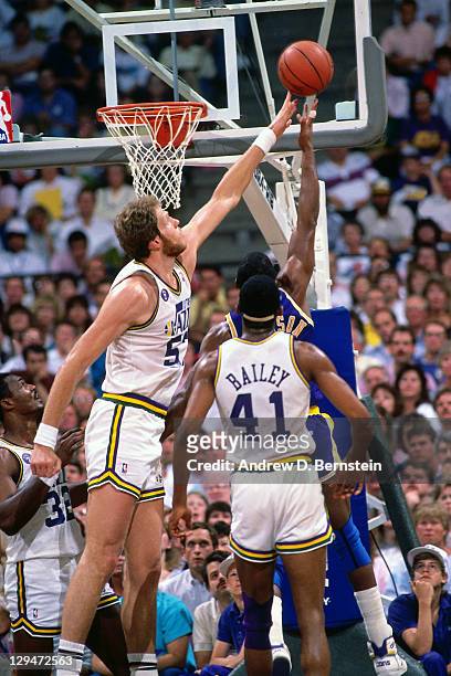 Mark Eaton of the Utah Jazz blocks a shot attempt by Magic Johnson of the Los Angeles Lakers circa 1987 at the Great Western Forum in Inglewood,...