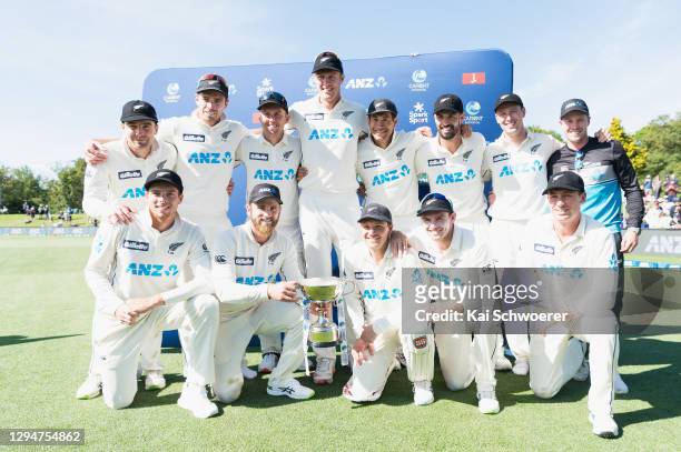 Captain Kane Williamson of New Zealand and his team mates pose with the trophy after their series win during day four of the Second Test match in the...