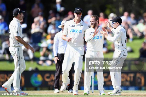 Captain Kane Williamson of New Zealand is congratulated by team mates after dismissing Shaheen Shah Afridi of Pakistan during day four of the Second...