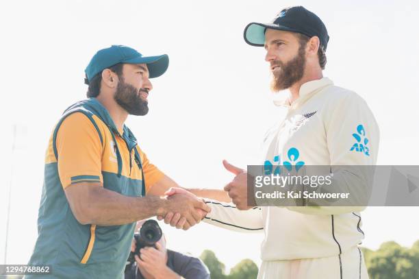 Captain Kane Williamson of New Zealand is congratulated by captain Mohammad Rizwan of Pakistan after the series win on day four of the Second Test...