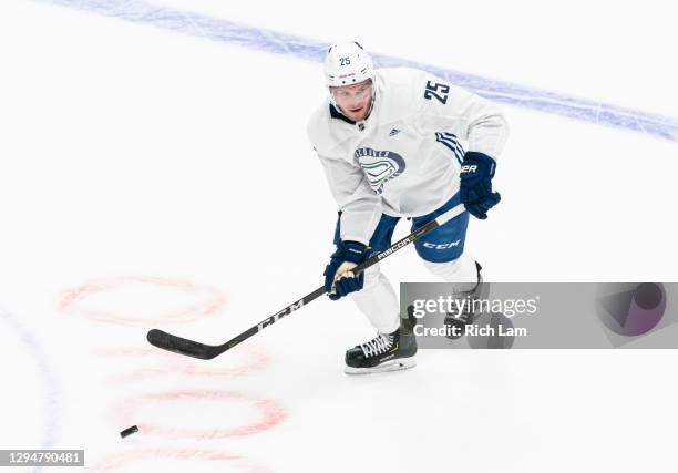 Brogan Rafferty of the Vancouver Canucks skates with the puck on the first day of the Vancouver Canucks NHL Training Camp on January 2021 at Rogers...