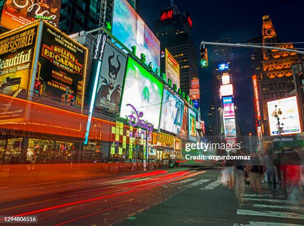 times square illuminated at night with yellow taxi cabs in traffic jam, advertising and billboards in background, manhattan, new york, usa - broadway imagens e fotografias de stock