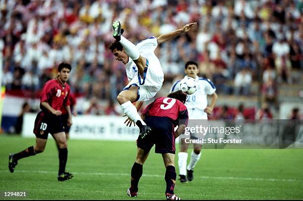 Carlos Gamarra of Paraguay tumbles over Juan Antonio Pizzi of Spain during the World Cup group D game at the Stade Geoffroy Guichard in St Etienne,...