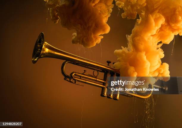 underwater trumpet with orange cloud - blues music stock-fotos und bilder