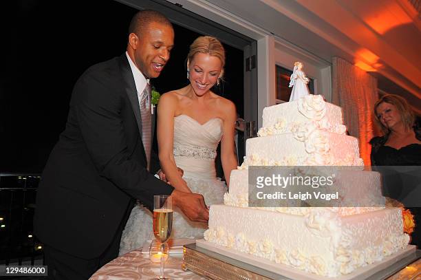 Craig Melvin and Lindsay Czarniak cut their wedding cake on their wedding day at the Hay Adams on October 15, 2011 in Washington, DC.