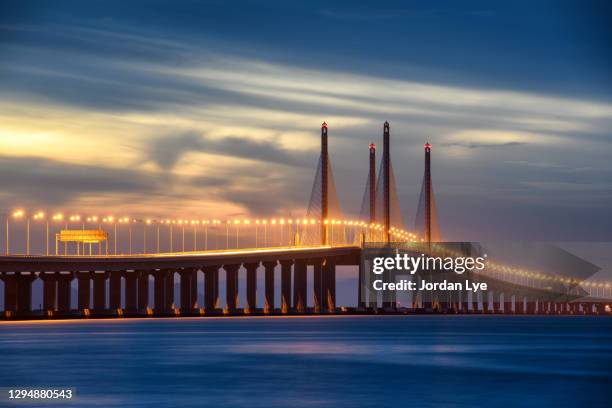 bridge over sea against sky during sunset - penang stockfoto's en -beelden