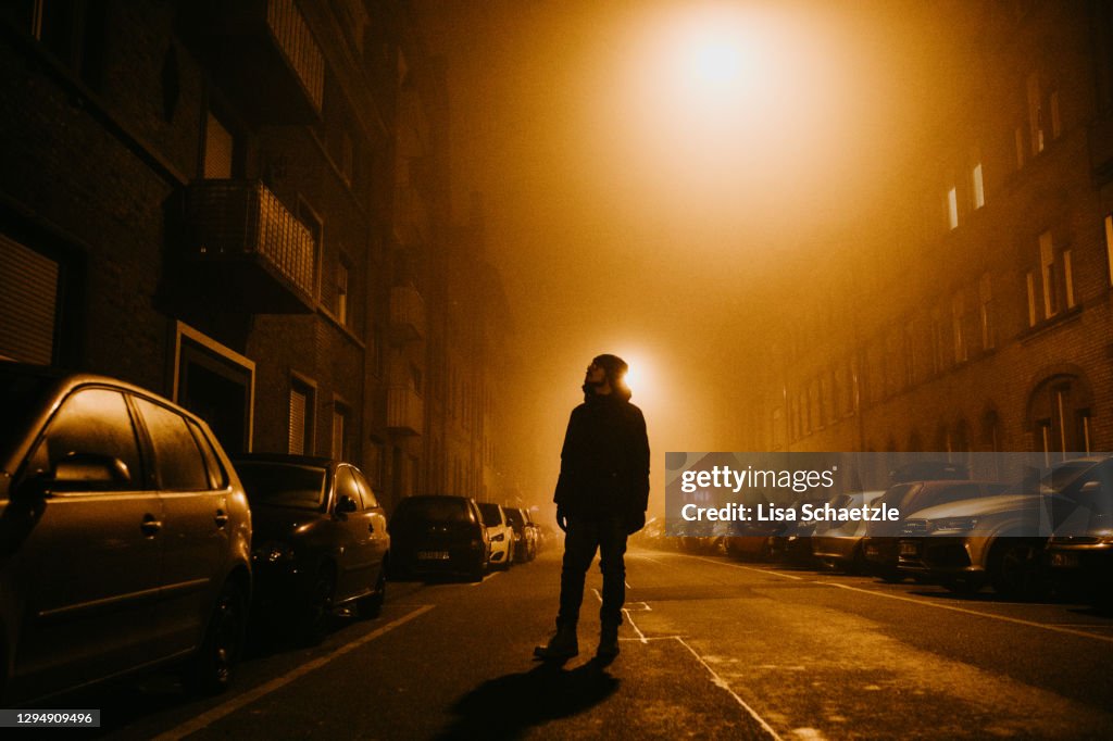 Portrait of Young man in the city in lights at night