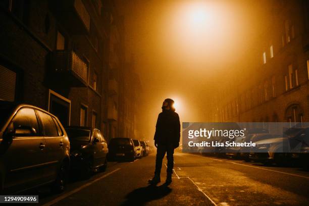 portrait of young man in the city in lights at night - curfew stock pictures, royalty-free photos & images