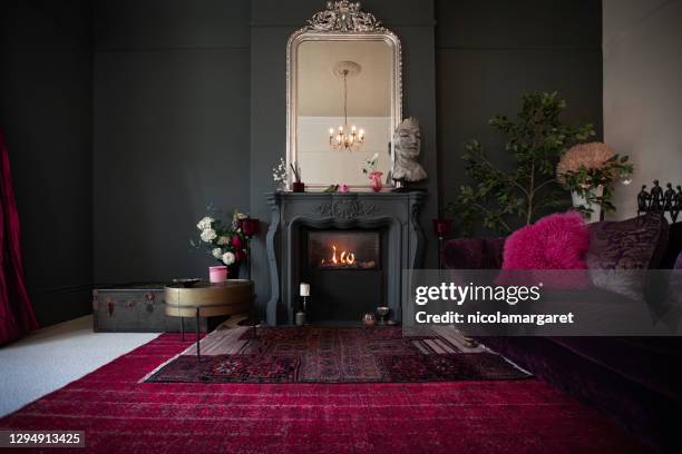 living room with dark walls and authentic fireplace - carpet decor stock pictures, royalty-free photos & images