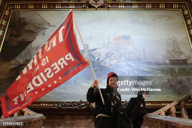 Protester holds a Trump flag inside the US Capitol Building near the Senate Chamber on January 06, 2021 in Washington, DC. Congress held a joint...