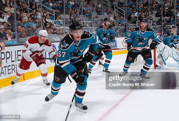 Right wing Tommy Wingels, defenseman Colin White, and defenseman Jason Demers of the San Jose Sharks skate up the ice against Right wingMikkei...