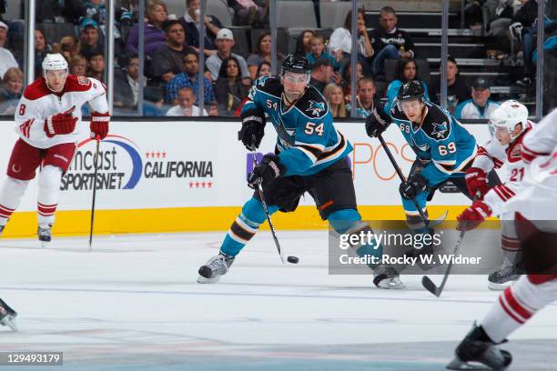 Defenseman Nick Petrecki of the San Jose Sharks looks to advance the puck against center Andy Miele of the Phoenix Coyotes at the HP Pavilion on...