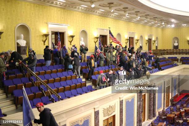 Protesters enter the Senate Chamber on January 06, 2021 in Washington, DC. Congress held a joint session today to ratify President-elect Joe Biden's...