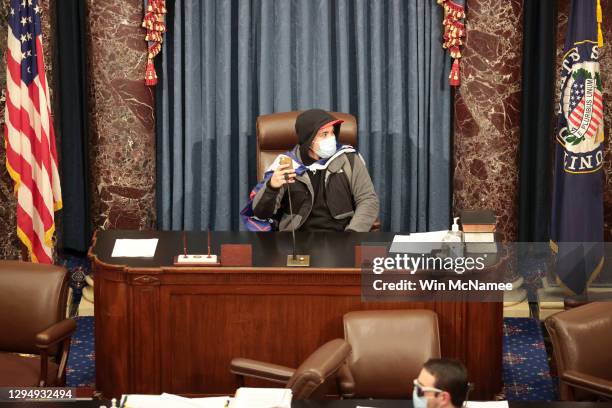 Protester sits in the Senate Chamber on January 06, 2021 in Washington, DC. Congress held a joint session today to ratify President-elect Joe Biden's...