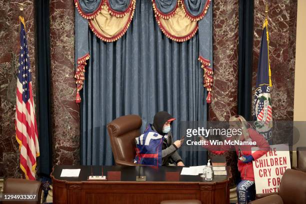Protester sits in the Senate Chamber on January 06, 2021 in Washington, DC. Congress held a joint session today to ratify President-elect Joe Biden's...