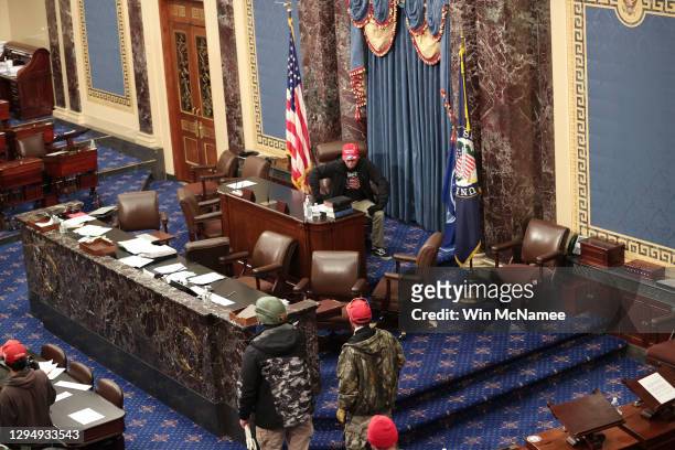 Protesters enter the Senate Chamber on January 06, 2021 in Washington, DC. Congress held a joint session today to ratify President-elect Joe Biden's...
