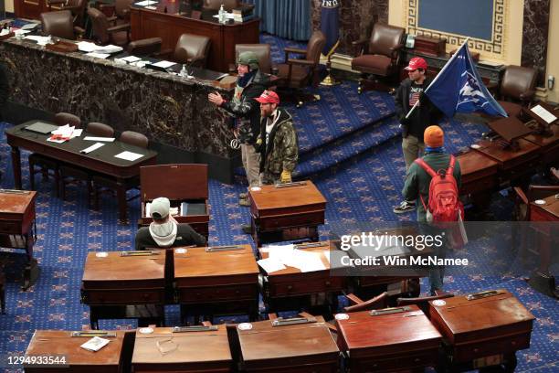 Protesters enter the Senate Chamber on January 06, 2021 in Washington, DC. Congress held a joint session today to ratify President-elect Joe Biden's...