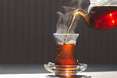 Glass cup of brewed black turkish tea, traditional hot drink concept