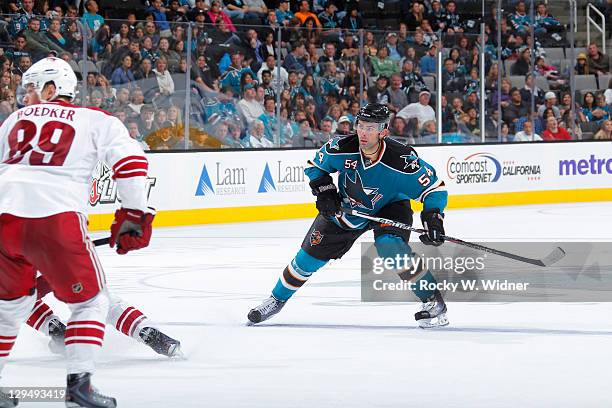 Defenseman Nick Petrecki of the San Jose Sharks skates for position against right wing Mikkei Boedker of the Phoenix Coyotes at the HP Pavilion on...
