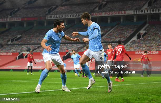 John Stones of Manchester City celebrates with Ruben Dias of Manchester City after scoring his sides 1st goal during the Carabao Cup Semi Final match...