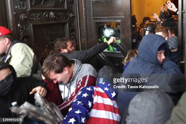 Protesters gather on the door of the U.S. Capitol Building on January 06, 2021 in Washington, DC. Pro-Trump protesters entered the U.S. Capitol...