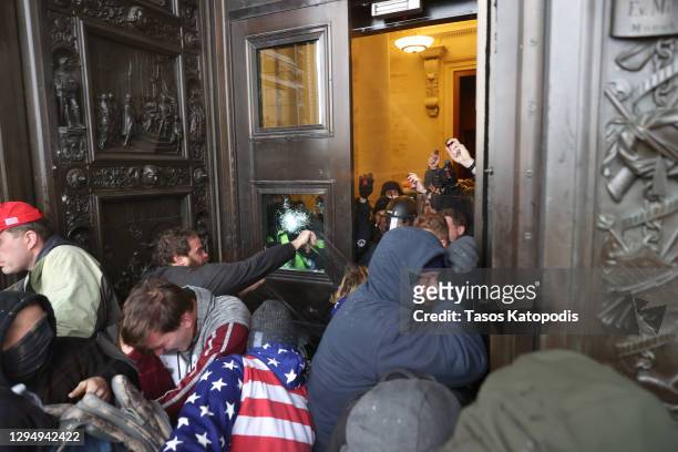 Protesters attempt to enter the U.S. Capitol Building on January 06, 2021 in Washington, DC. Pro-Trump protesters entered the U.S. Capitol building...