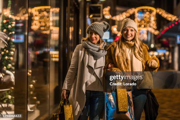 two beautiful women at winter shopping - netherlands christmas stock pictures, royalty-free photos & images