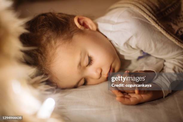 little preschool girl sleeping in comfortable bed - nursery night stock pictures, royalty-free photos & images