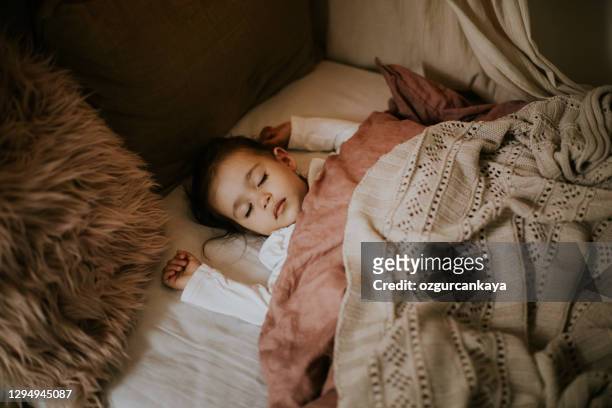 little preschool girl sleeping in comfortable bed - nursery night stock pictures, royalty-free photos & images
