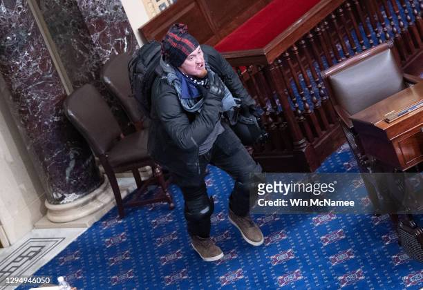 Protester supporting U.S. President Donald Trump moves to the floor of the Senate chamber at the U.S. Capitol Building on January 06, 2021 in...