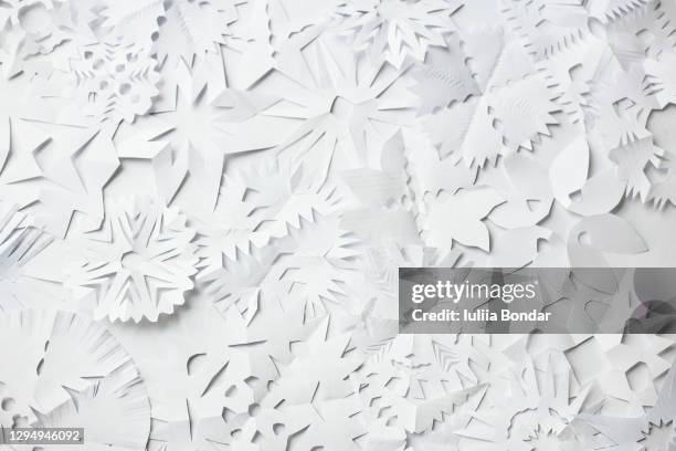 paper snowflake cutouts on white background. - holiday greeting stock pictures, royalty-free photos & images