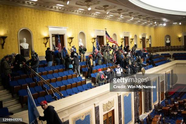 Pro-Trump mob gathers inside the Senate chamber in the U.S. Capitol after groups stormed the building on January 06, 2021 in Washington, DC. Congress...