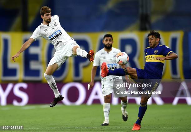 Luan Peres of Santos and Eduardo Salvio of Boca Juniors fights for the ball with during a semifinal first leg match between Boca Juniors and Santos...