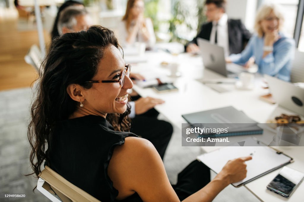 Candid Close-Up of Hispanic Businesswoman in Office Meeting