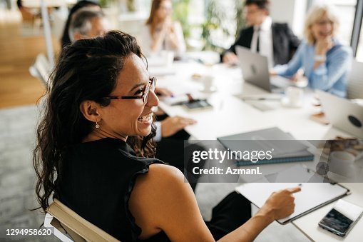 Candid Close-Up of Hispanic Businesswoman in Office Meeting Candid Close-Up of Hispanic Businesswoman in Office Meeting