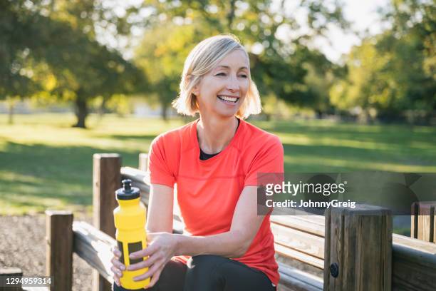outdoor portrait of early 50s female athlete after workout - beautiful woman waist up stock pictures, royalty-free photos & images