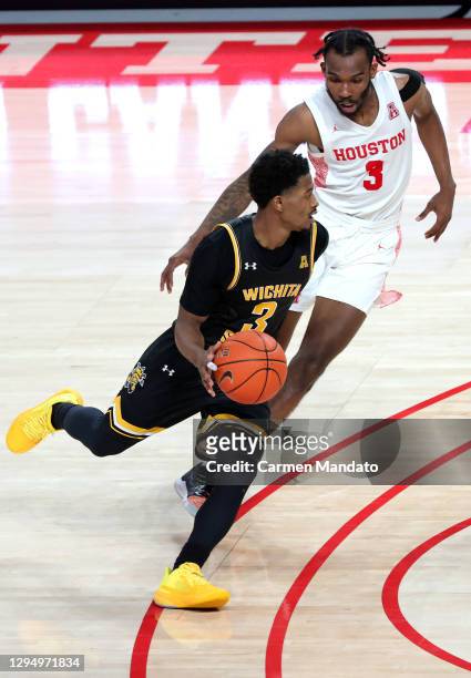 Alterique Gilbert of the Wichita State Shockers drives against DeJon Jarreau of the Houston Cougars during the second half of a game at Fertitta...